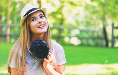 Female photographer with a DSLR camera outside