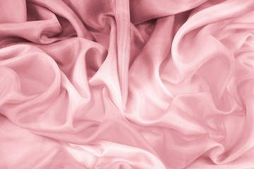 The texture of the satin fabric of pink color for the background 