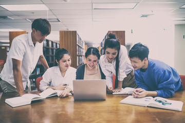 Group of young people studying at the public libery. © ibravery