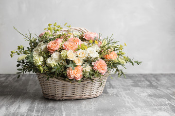 Beautiful flower composition a bouquet in a wicker basket. Floristry concept. Spring colors