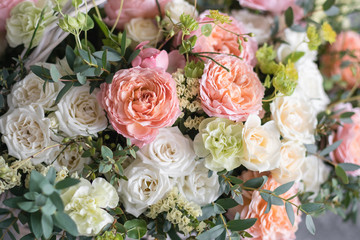 Beautiful flower composition a bouquet in a wicker basket. Floristry concept. Spring colors