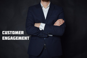 A businessman shows an inscription:CUSTOMER ENGAGEMENT