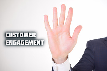 A businessman shows an inscription:CUSTOMER ENGAGEMENT