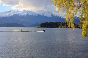 Jet Skiing by Snowcapped Mountains