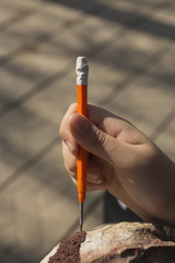 The hand of the artist. Work with a sharp tool. The execution of the decorative sculpture made of paper.