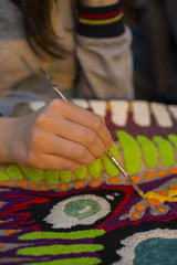 The hand of the artist. Work with a sharp tool. The execution of the decorative sculpture made of...