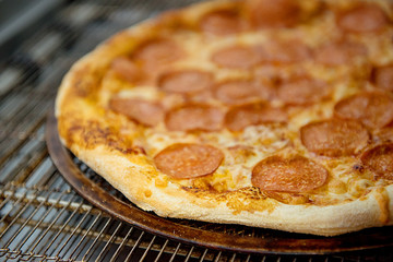 Cooked pepperoni pizza close-up.The process of cooking pizza.