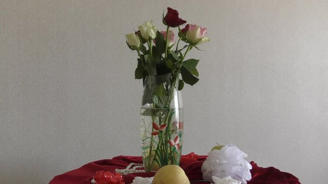 Still life of wedding wine glasses and a bouquet of roses