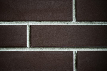 Fototapeta premium background of a brick dark wall, tile texture with a smooth pattern.