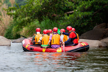 Young person rafting on the river, extreme and fun sport at tourist attraction natural park