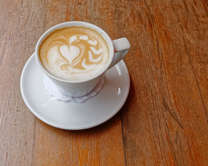 hot caffe latte cup on brown wood background
