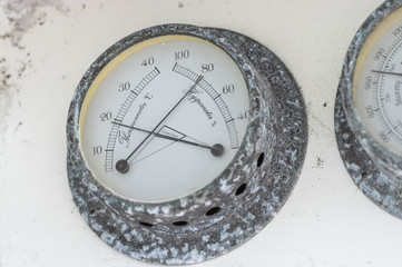 Fototapeta na wymiar Ship's barometer and thermometer corroded by sea salt