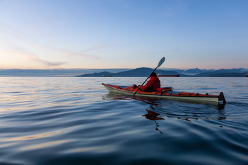 Ocean Kayaking during Sunset. Taken in Vancouver, British Columbia, Canada. Concept: sport,...