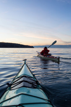 Ocean Kayaking during Sunset. Taken in Vancouver, British Columbia, Canada. Concept: sport, adventure, fitness, vacation, holiday.