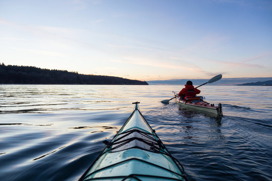 Ocean Kayaking during Sunset. Taken in Vancouver, British Columbia, Canada. Concept: sport, adventure, fitness, vacation, holiday.