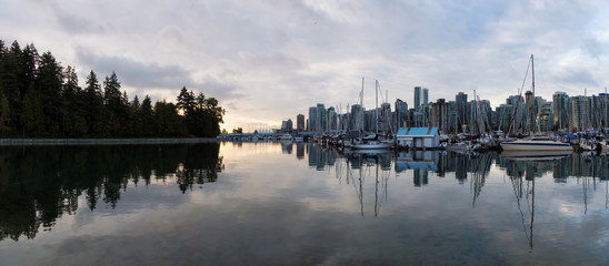 Fototapeta na wymiar Sail Boats in a marina during a vibrant sunrise. Taken in Stanley Park, Coal Harbour, Downtown Vancouver, BC, Canada.