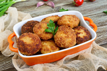 Cutlets. Fried cutlets in a ceramic bowl on a wooden table.