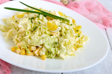 Light spring dietary salad from Chinese cabbage, cheese, quail eggs, corn. Proper nutrition.