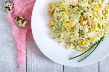 Light spring dietary salad from Chinese cabbage, cheese, quail eggs, corn. Proper nutrition. Top view.