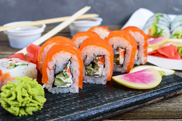 Various kinds of sushi served on wooden background. Sushi menu. Japanese food. Sushi set.