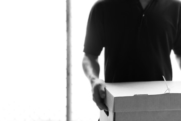 Man sending paper box locked with seal plastic.