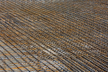Fragment of the frame from the reinforcement, for pouring the formwork of the future building.