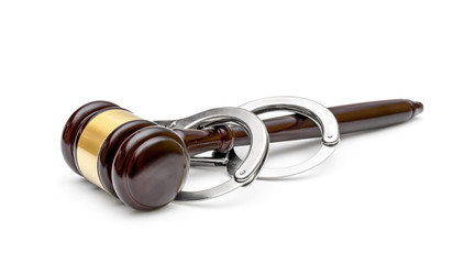 Gavel with handcuffs on a white background.
