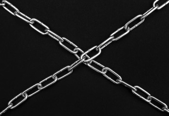 Fototapeta na wymiar Crossed chains on black background. Security concept.