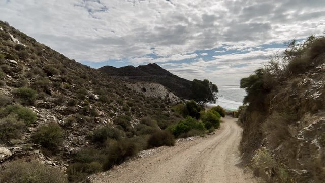 driving on off road tracks in the puntas de calnegre natural park on the coast in murcia, spain