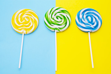 colorful lollipops on yellow and blue background