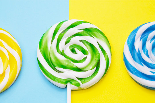 colorful lollipops on yellow and blue background