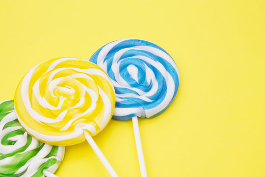 colorful lollipops on yellow background
