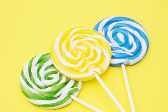 colorful lollipops on yellow background
