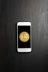 Bitcoin gold on the Smartphone. new cryptocurrency concept
