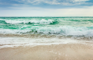 Fototapeta na wymiar crushing waves on sandy beach. weather before the morning storm