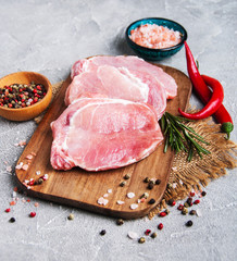 Fresh raw pork chops with spices and herbs
