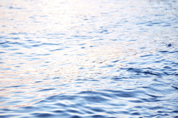 Small waves on the sea. Evening sea with the reflection of the sun in the water