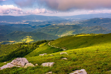 Fototapeta premium lovely landscape on Runa mountain. summer scenery on a cloudy day in beautiful light. huge rocks on a grassy meadow