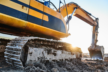 excavation work. Excavator at construction site with sunset