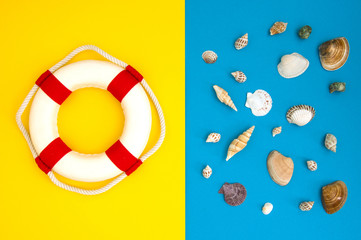 Lifebuoy and shell on a blue background. Travel vacation concept. Summer background. Flat lay, top view.