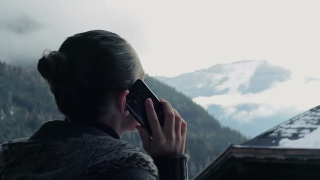 Attractive woman talking on cellphone in the mountains, Alps, Austria

