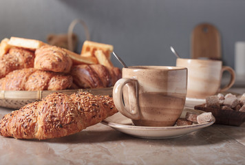 Breakfast with black coffee and fresh pastries.