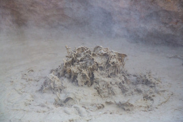 detailed view bubbling and boiling mud pot in iceland, drops, vapor