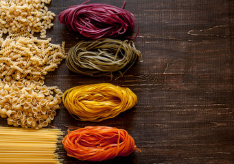 Variety of kinds and forms of dry macaroni. Italian macaroni raw food or texture: pasta, spaghetti, pasta in the form of a spiral.