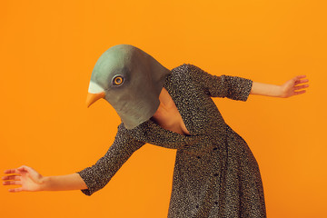 Woman wearing pigeon mask and going to run