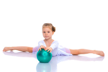 little girl is engaged in fitness with a ball.