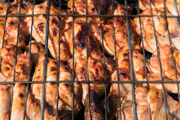 Top view on chicken legs on grill.