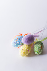 Easter eggs on a stick on a white background