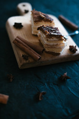Cake on a wooden tray on a black matte background