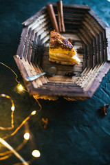 Cake on a wooden tray on a black matte background